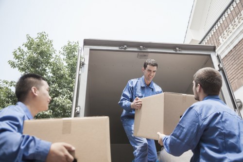 Packed moving boxes and furniture ready for transport in Kingston