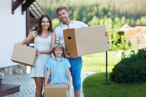 Local moving team handling fragile items with packing supplies in Kingston