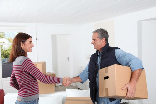 Movers carrying boxes during urgent removals in Kingston